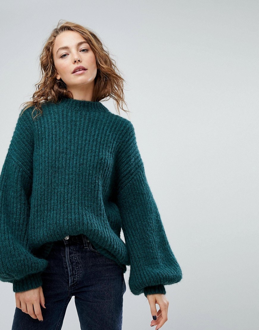 Cozy and comfortable this sweater in a vibrant shade of teal is a great choice for off duty attire. Wear it with your favorite pair of denim and tall boots.