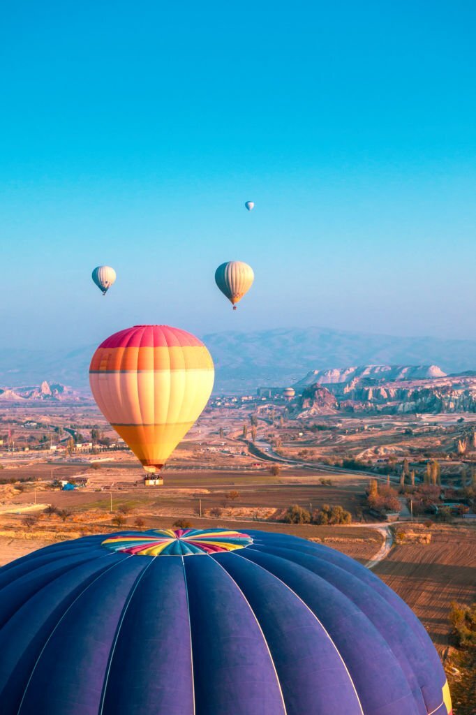 For your next trip take a ride beneath a vibrant sky above the bizarre Cappadocian scenery.
