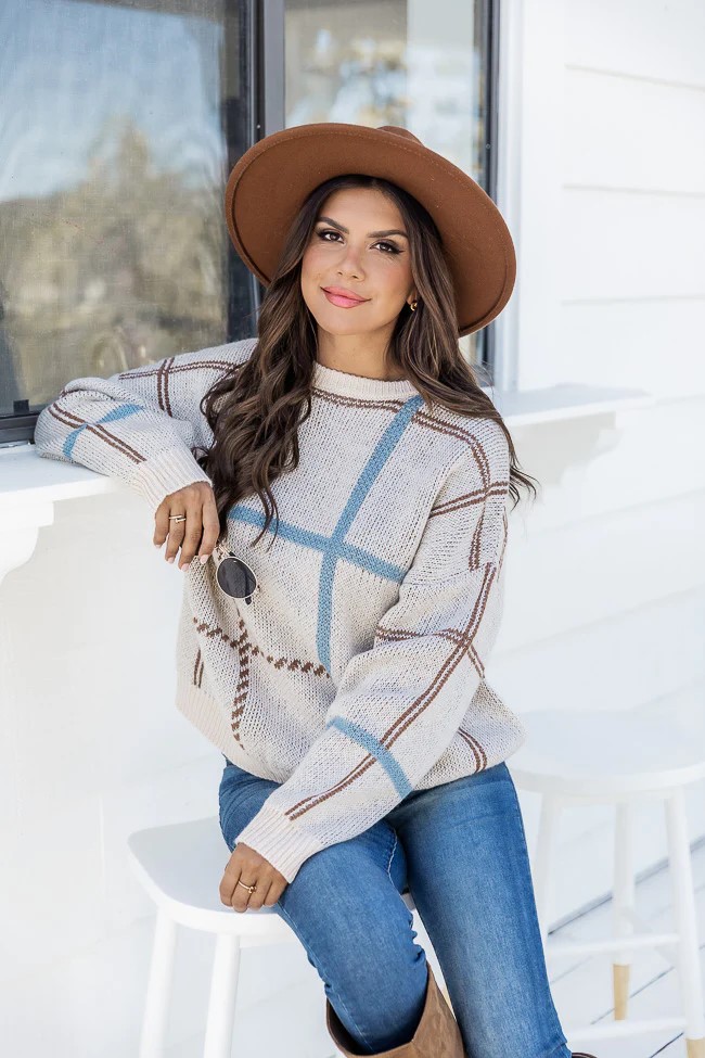 Put on this chic beige sweater with some stretchy knit boots and youll have a great go to outfit for every day. Featuring a boat neckline long sleeves and a ribbed hem.