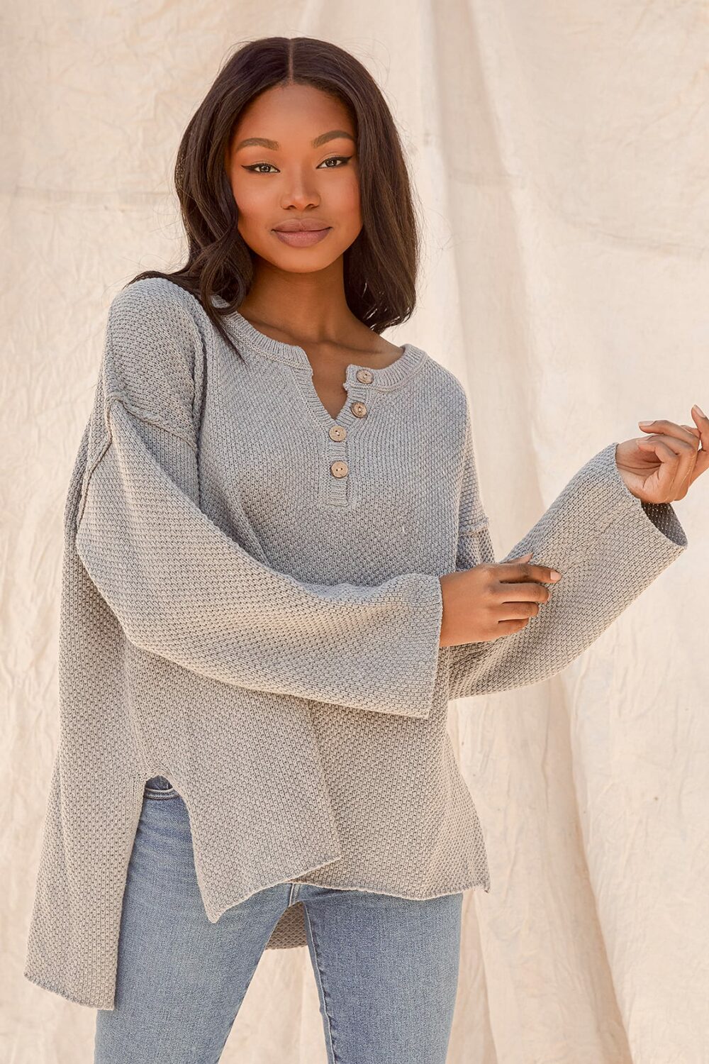 This fall cuddle up in a comforting Grey Knit Oversized Sweater. This cozy knit has a round neck long sleeves and dropped shoulders and is made from a cotton blend.
