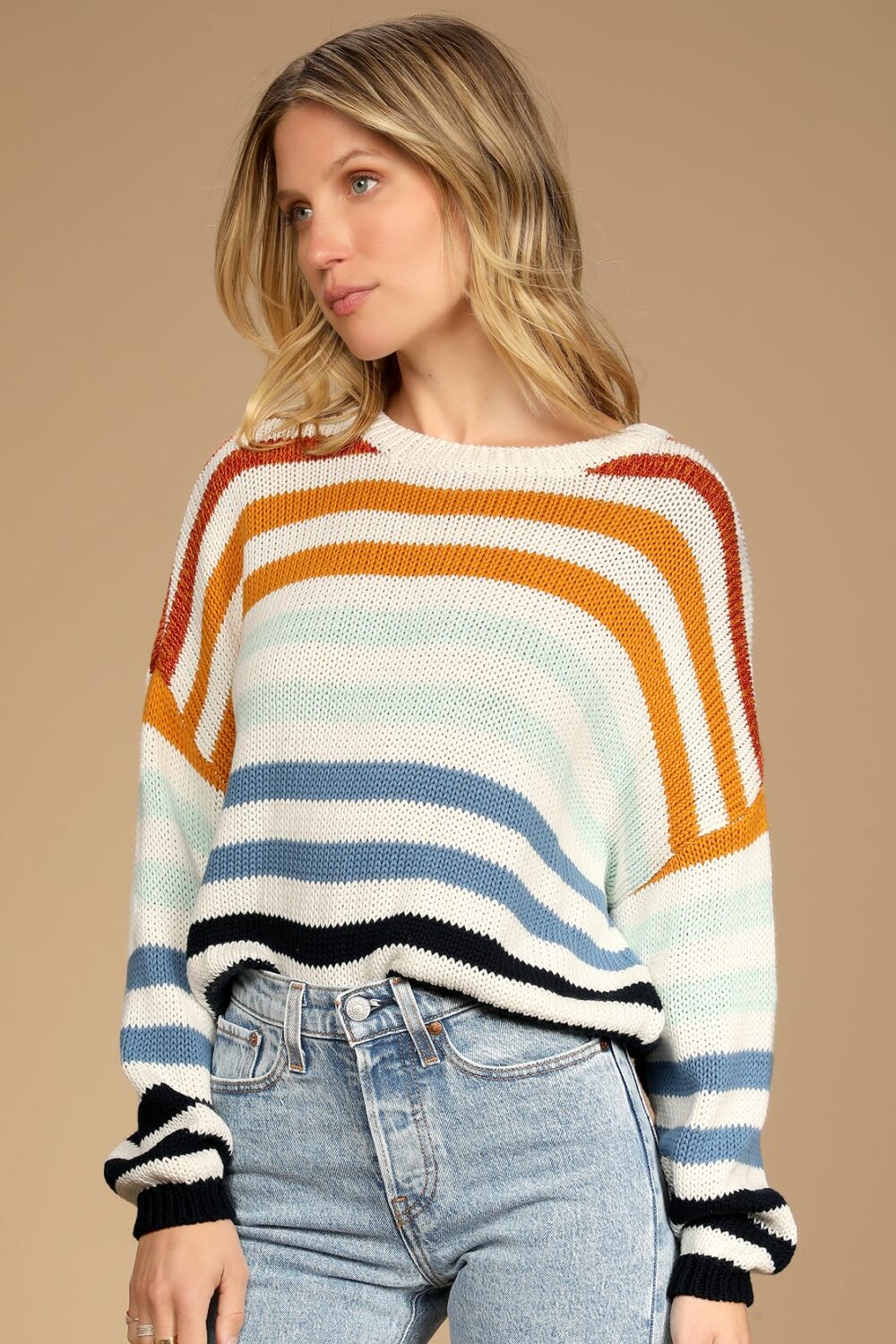 This season youll live in this Charli Sweater. It has a chic rounded neckline a stripe pattern that varies in hue from rust red to mustard yellow to light blue to cobalt blue to navy blue.