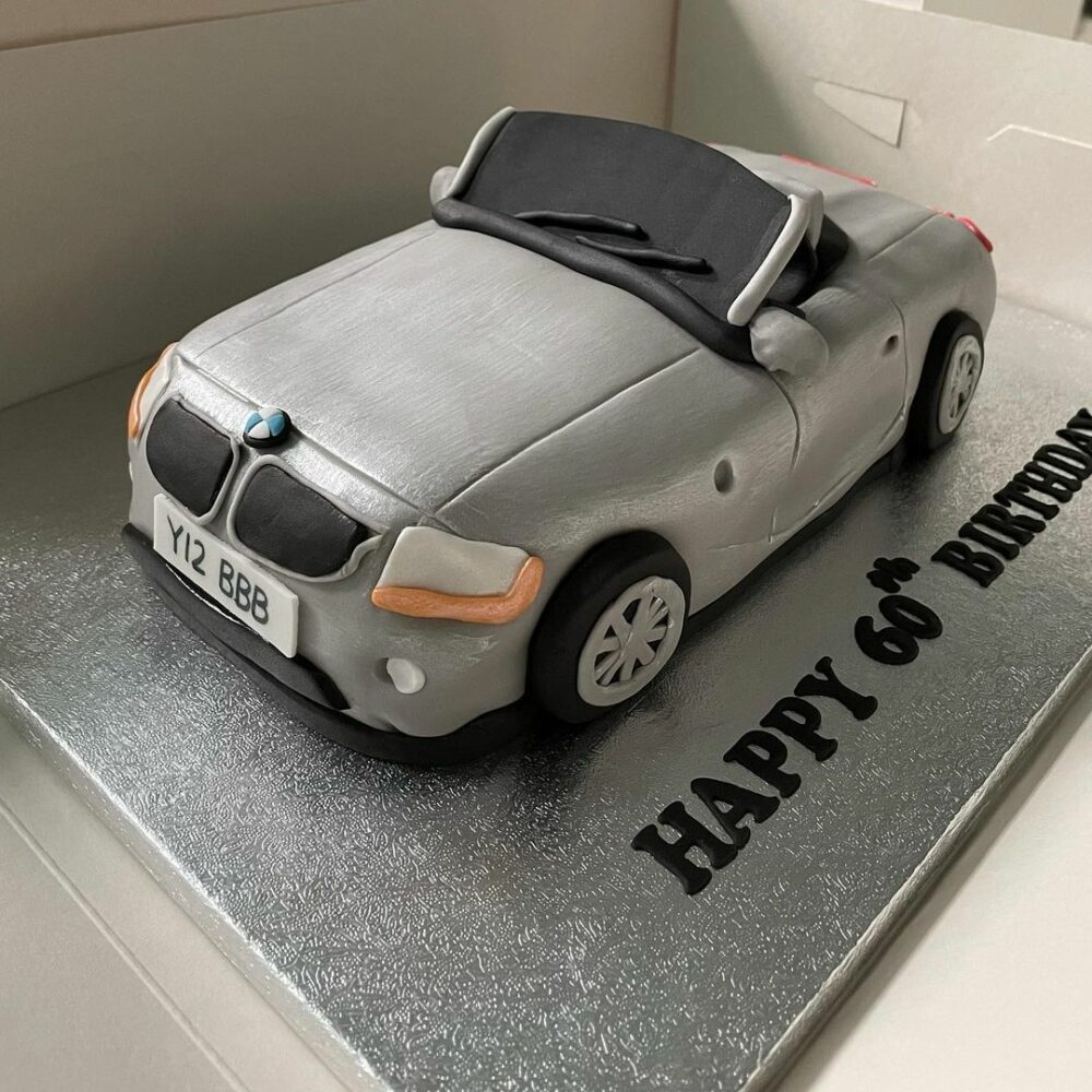 People who enjoy traveling in style will find that this silver colored cake with a car travel motif is the ideal dessert for them to enjoy.